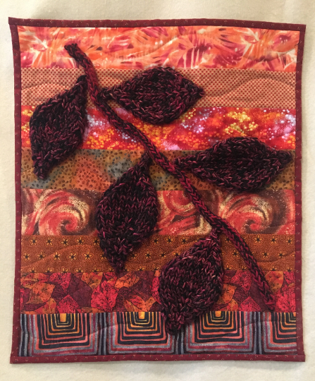 Small art quilt with leaves.